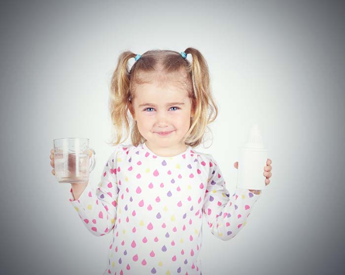 A cute girl holding glass of water