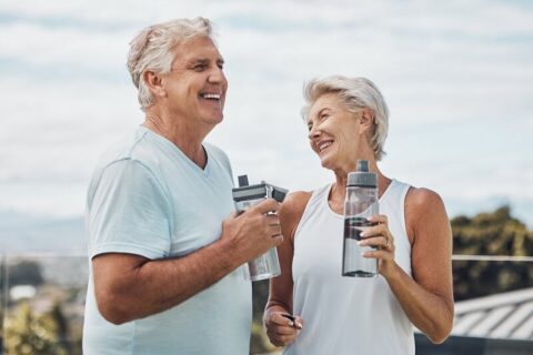 older couple outdoors drinking water